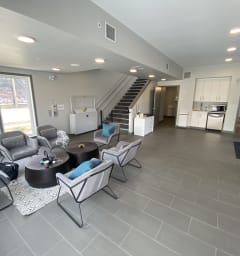 a kitchen and living room with a large island with stools