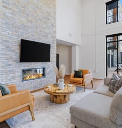a living room with a fireplace and a tv on the wall