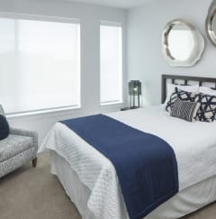 a bedroom with a bed and a chair