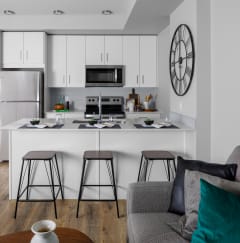 a kitchen with white cabinetry and stainless steel appliances
