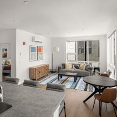 A modern kitchen with a dining table and chairs.