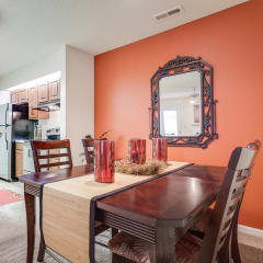 a dining room with a table and chairs and a kitchen in the backgroundat Arbors at Windsor Lake, Columbia South Carolina