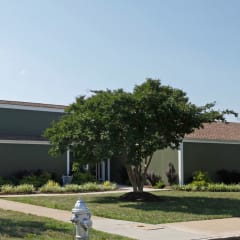 a gray building with a white fire hydrant in front of it