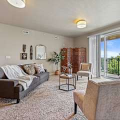 A living room with a brown couch, a chair, and a coffee table.