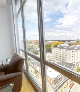 a living room with large windows and a view of a city