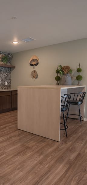 a kitchen and dining area with a refrigerator and a table and chairs