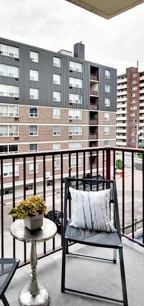 a living room with a couch and a table on a balcony