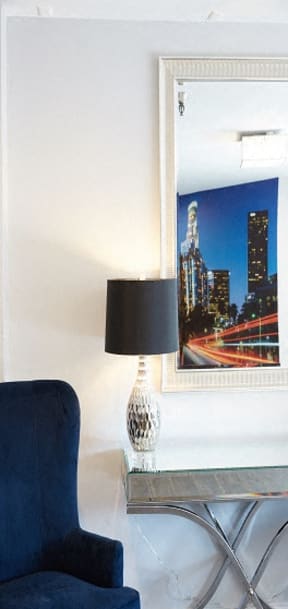 a living room with a lamp and a picture on the wall