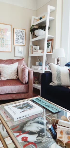 Pink chair next to coffee table in living room