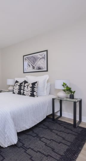 a bedroom with a large bed and a chair in a 555 waverly unit