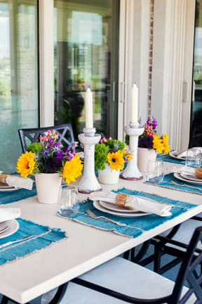 a dining table set for a meal on a patio