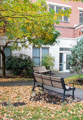 a park bench sitting in front of a building