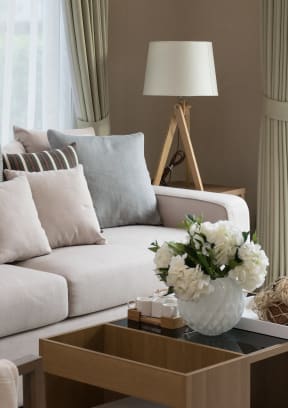 a living room with a white couch and a coffee table