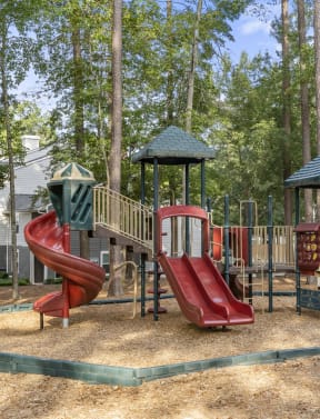a playground with two slides and a swing set at Trails at Short Pump Apartments, Richmond, VA, 23233