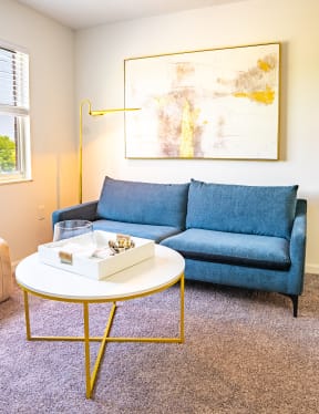 a living room with a blue couch and a coffee table
