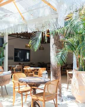 A patio with a table and chairs under a white canopy.