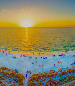 arial view of people on the beach at sunset