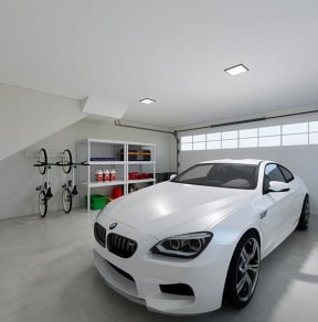 a white car parked in a garage next to a bike