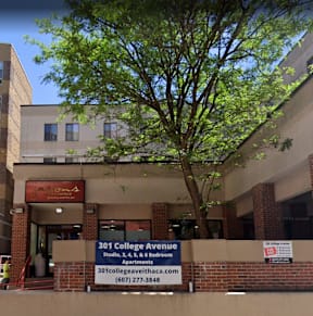 A building with a sign that says "301 College Avenue" and a website address below it.