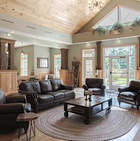 A living room with a brown leather couch and a coffee table.