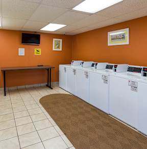 A laundromat with rows of washers and dryers.