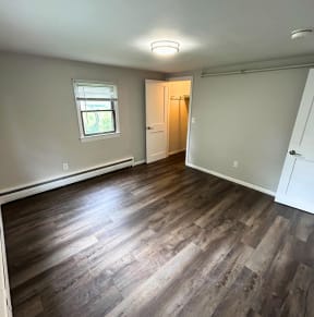 an empty living room with hardwood floors