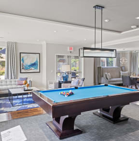 a large living room with a pool table in the middle of it