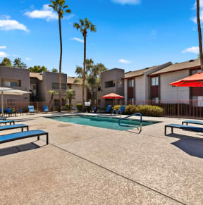 our apartments have a swimming pool with chairs and umbrellas