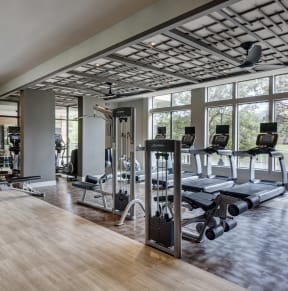 an image of a fitness room with treadmills and other exercise equipment