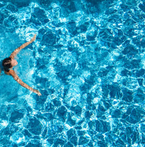 a woman swimming in a pool