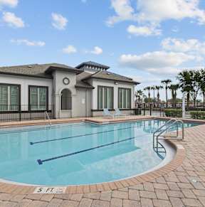 A small pool in front of a house.