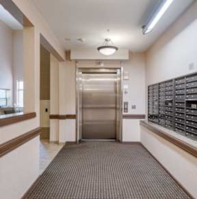A spacious gym with a variety of equipment including a treadmill, weights, and a bench.