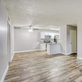 A kitchen with a granite countertop and white cabinets.
