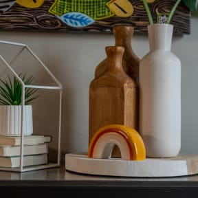 a shelf with vases and books on it