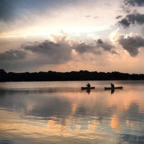 two people in a boat on a lake