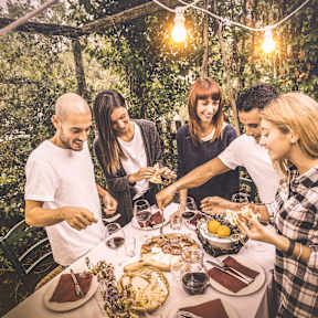 A group of people are gathered around a table enjoying a meal together at Beckett Farms Apartments, PRG Real Estate Management, Fort Mill