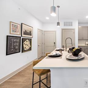 an open kitchen with a large island with a white counter top