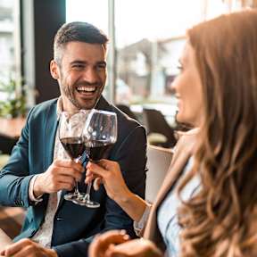 A man and a woman are enjoying a glass of wine together.