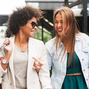 Three women are walking together and talking.