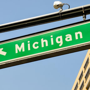 A green street sign that says Michigan.