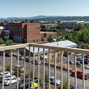 A parking lot with cars and a building in the background.