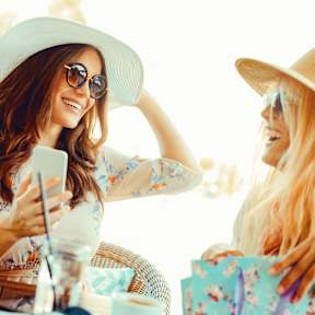 Two woman wearing hats at White Oak Gardens, Encino, 91316