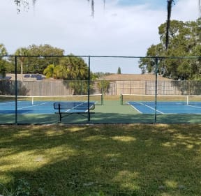 Open Tennis Court at L'Estancia Apartments in Sarasota, FL
