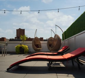 a red lounge bench on a roof top patio at 34 Berry, Brooklyn, 11249