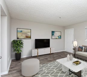 A living room with a couch, a television, and a potted plant.