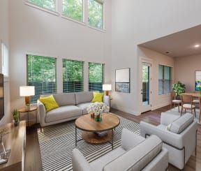 a living room with couches and chairs and a table