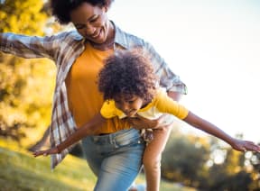 a mother and daughter playing in the park
