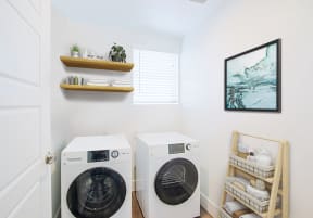 a kitchen with white cabinets and black appliances