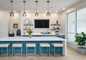 a kitchen with a large white island with a blue countertop and five stools in front  at Promenade at Newnan Crossing, Newnan, 30265