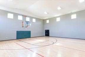 the inside of an empty gym with a basketball court